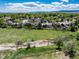 Picturesque neighborhood with mature trees and a large open field, providing a serene living environment at 10220 W Montgomery Ave, Littleton, CO 80127