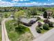 Aerial view of a one story home with mature landscaping and a long driveway at 10220 W Montgomery Ave, Littleton, CO 80127