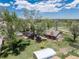 Backyard aerial view with mature trees, well-maintained yard and privacy fence at 10220 W Montgomery Ave, Littleton, CO 80127