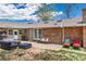 Charming backyard patio featuring comfortable seating, a brick facade, and a serene outdoor ambiance at 10220 W Montgomery Ave, Littleton, CO 80127