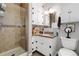 Well-lit bathroom featuring a glass-enclosed shower, granite counters, and modern fixtures at 10220 W Montgomery Ave, Littleton, CO 80127
