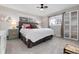 Comfortable bedroom featuring a queen-size bed, neutral decor, two windows, and ample closet space at 10220 W Montgomery Ave, Littleton, CO 80127