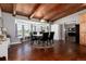 Elegant dining room features a wood beamed ceiling, bay window and hardwood floors at 10220 W Montgomery Ave, Littleton, CO 80127