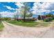 Exterior view of a one story home with a gravel driveway, mature trees and landscaping at 10220 W Montgomery Ave, Littleton, CO 80127