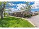 Landscaped home with brick accents, a well-manicured lawn, and a charming, covered front porch at 10220 W Montgomery Ave, Littleton, CO 80127