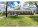 Charming ranch-style home featuring a brick facade, large bay window, and well-maintained front yard at 10220 W Montgomery Ave, Littleton, CO 80127