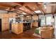 Gourmet kitchen featuring wood cabinetry, a center island with seating, and stainless steel appliances at 10220 W Montgomery Ave, Littleton, CO 80127