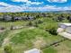 Vast green field surrounded by homes, trees, and a beautiful mountain range at 10220 W Montgomery Ave, Littleton, CO 80127