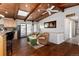 Inviting living area with wood-beamed ceilings, hardwood floors, and comfortable seating at 10220 W Montgomery Ave, Littleton, CO 80127