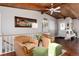 Cozy living area with wood-beamed ceilings, hardwood floors, and a neutral color scheme at 10220 W Montgomery Ave, Littleton, CO 80127