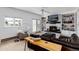 Cozy living room with a fireplace, built-in shelving, comfortable seating, and natural wood accents at 10220 W Montgomery Ave, Littleton, CO 80127