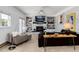 Inviting living room with brick fireplace, built-in shelves, modern seating, and lots of natural light at 10220 W Montgomery Ave, Littleton, CO 80127