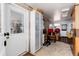 Comfortable room with brick walls, tile floor, a seating area and a door leading to the outside at 10220 W Montgomery Ave, Littleton, CO 80127