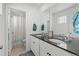 Bathroom with double vanity, dark countertops, and a shower/tub at 697 N Bersshine Ct, Watkins, CO 80137