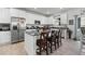 Modern kitchen with white cabinets, stainless steel appliances, and an island at 697 N Bersshine Ct, Watkins, CO 80137