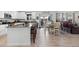 Kitchen with island, stainless steel appliances, and white cabinets at 697 N Bersshine Ct, Watkins, CO 80137