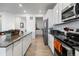 Kitchen with island, stainless steel appliances, and white cabinets at 697 N Bersshine Ct, Watkins, CO 80137