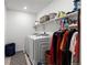 Laundry room with washer, dryer, shelving, and hanging space at 697 N Bersshine Ct, Watkins, CO 80137