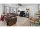 Spacious living room featuring a comfortable couch and large TV at 697 N Bersshine Ct, Watkins, CO 80137