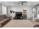 Spacious living room with large TV, comfortable seating, and natural light at 697 N Bersshine Ct, Watkins, CO 80137