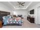 Spacious main bedroom with fireplace, large bed, and plenty of light at 697 N Bersshine Ct, Watkins, CO 80137