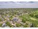 An aerial view of a home in a neighborhood next to a golf course showcasing surrounding greenery and the property's location at 2539 N York St, Denver, CO 80205