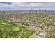 Real estate aerial view highlights the house's location near a golf course, surrounded by lush trees, and downtown at 2539 N York St, Denver, CO 80205