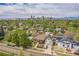 Real estate aerial view showcases the neighborhood, the property's proximity to downtown and the surrounding trees at 2539 N York St, Denver, CO 80205