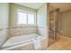 Spa-like bathroom features a soaking tub, glass shower, and stylish tile work at 2539 N York St, Denver, CO 80205
