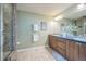 Spacious bathroom boasting a double vanity, tiled shower, and neutral color scheme at 2539 N York St, Denver, CO 80205