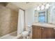 Compact bathroom featuring a shower with curtain, single sink, and neutral finishes at 2539 N York St, Denver, CO 80205