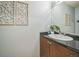 Bathroom featuring a granite-topped vanity, decorative mirror, and stylish design elements at 2539 N York St, Denver, CO 80205