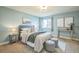 Bright bedroom with soft blue walls, plush bedding, and complementary decor at 2539 N York St, Denver, CO 80205