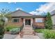 Inviting front exterior with beautiful landscaping, flowers, and a stone facade at 2539 N York St, Denver, CO 80205