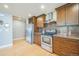 Modern kitchen showcasing stainless steel appliances, dark wood cabinets, and mosaic backsplash at 2539 N York St, Denver, CO 80205