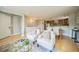 Open-concept living area with hardwood floors, neutral decor, and seamless flow to dining at 2539 N York St, Denver, CO 80205