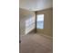 Bright bedroom with large window and neutral colored carpet at 4764 S Duquesne St, Aurora, CO 80016