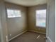 Cozy bedroom with neutral walls, carpet, and two windows providing natural light at 4764 S Duquesne St, Aurora, CO 80016