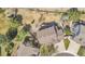 Aerial view of a well-maintained home with lush backyard, a deck, patio, and mature trees at 9411 La Quinta Way, Lone Tree, CO 80124