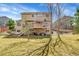 Beautiful backyard with a well-manicured lawn, a deck, patio, and mature trees for a serene outdoor space at 9411 La Quinta Way, Lone Tree, CO 80124