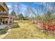 Spacious backyard with lush green grass, a brick wall, and a multi-level deck, great for outdoor enjoyment at 9411 La Quinta Way, Lone Tree, CO 80124