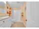 Bright bathroom featuring a shower-tub, white cabinets, neutral-colored walls, and tile flooring at 9411 La Quinta Way, Lone Tree, CO 80124