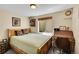 Cozy bedroom with natural light, a comfortable bed, and a charming wooden desk, perfect for relaxation at 9411 La Quinta Way, Lone Tree, CO 80124