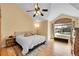 Bedroom featuring hardwood floors, vaulted ceilings, and bright window light at 9411 La Quinta Way, Lone Tree, CO 80124