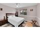 Bedroom features a bed with white comforter, wood floors and a window with natural light at 9411 La Quinta Way, Lone Tree, CO 80124