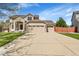 Charming two-story home with a three-car garage and well-maintained front lawn and a brick and siding exterior at 9411 La Quinta Way, Lone Tree, CO 80124