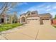 Beautiful two-story home featuring a three-car garage, and a well-manicured lawn at 9411 La Quinta Way, Lone Tree, CO 80124