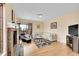 Inviting living room with a fireplace, hardwood floors, and ample seating at 9411 La Quinta Way, Lone Tree, CO 80124