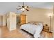 Spacious bedroom featuring hardwood floors and sliding barn door to ensuite bath at 9411 La Quinta Way, Lone Tree, CO 80124