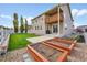 Large backyard with a patio, upper deck, garden beds, and ample green space at 5478 Teton Dr, Longmont, CO 80504